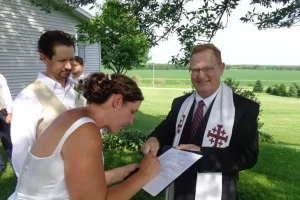 bride and groom signing certificate amana colonies wedding officiant
